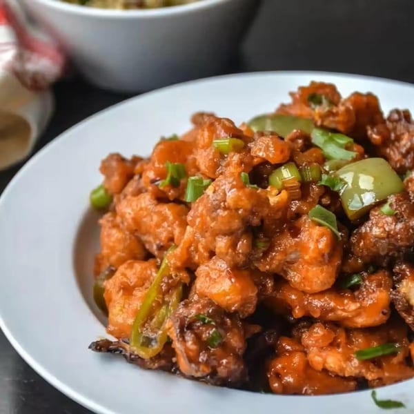 Close-up of Bawarchi Biryanis' Indian chili chicken with green peppers and scallions.